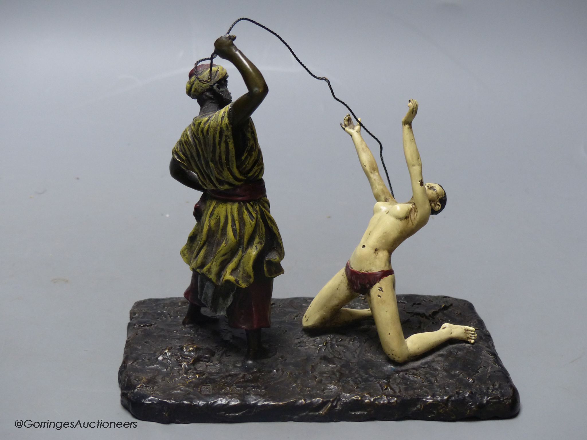 Attributed to Franz Bergmann, a cold painted bronze model of a slave trader, whipping a nude slave, stamped with shield and 'Nan Creb'